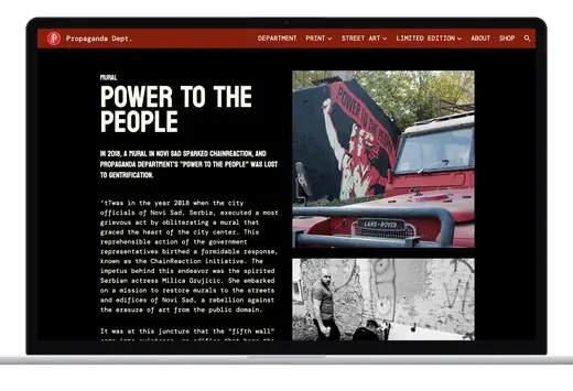 The Power To The People page on a laptop: the title and its story beside two photographs, the red and black mural behind an old red Land Rover, and the crew at the wall in black and white