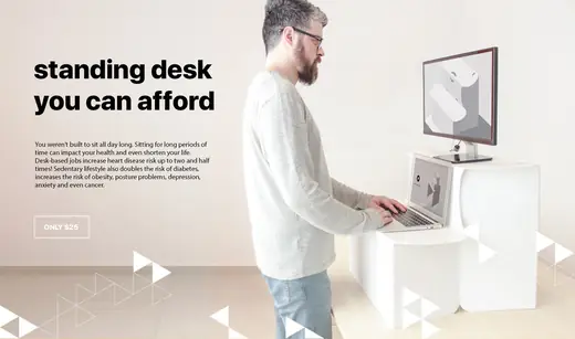 Man working at a laptop on a Standify standing desk