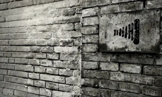 Marshaling Yard: A brick wall with an old railway sign