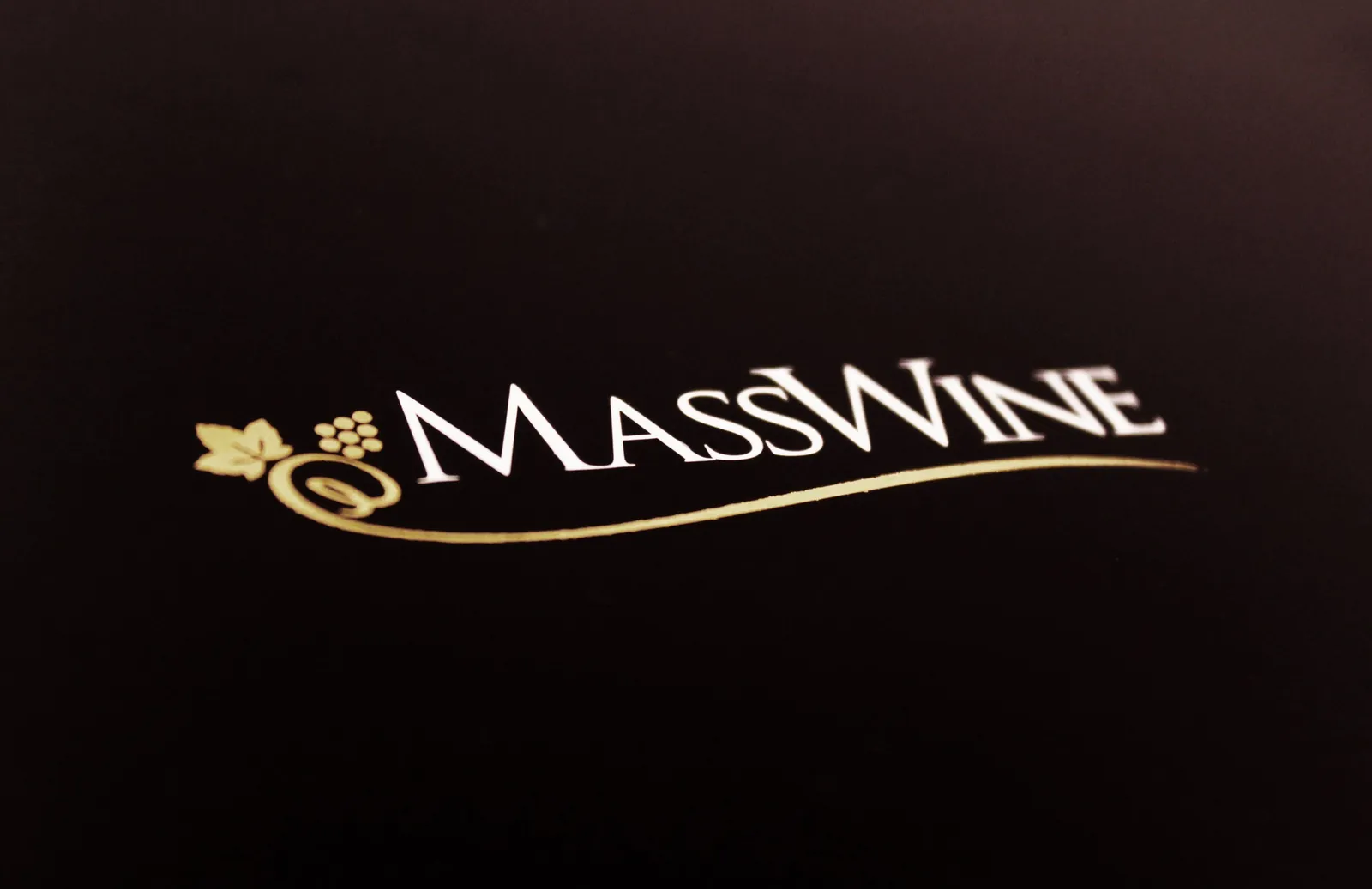 MassWine: the MassWine logo, a vine leaf and grapes with the name in script, embossed in gold on a black cover