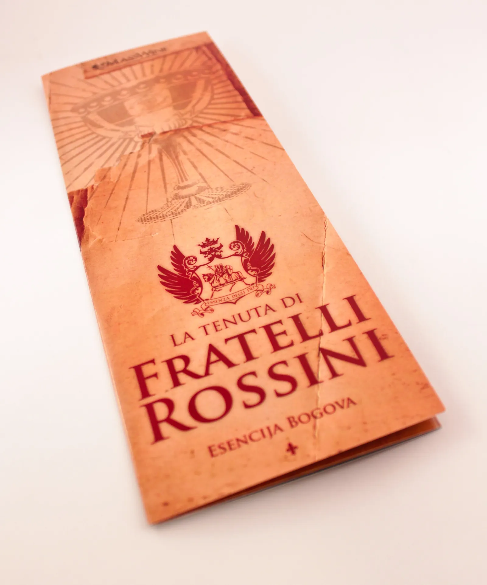 MassWine: the Fratelli Rossini brochure standing, red crest and name on aged orange paper
