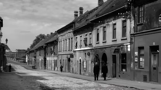 Peterwardein: A quiet street of old houses with two figures walking