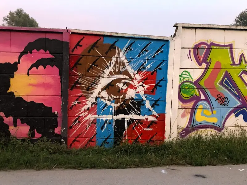 graffiti done with splatters showing overseeing eye in the triangle