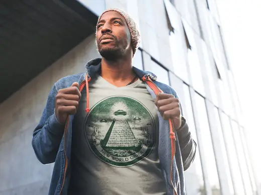 man wearing t-shirt with the ufo hovering over pyramid