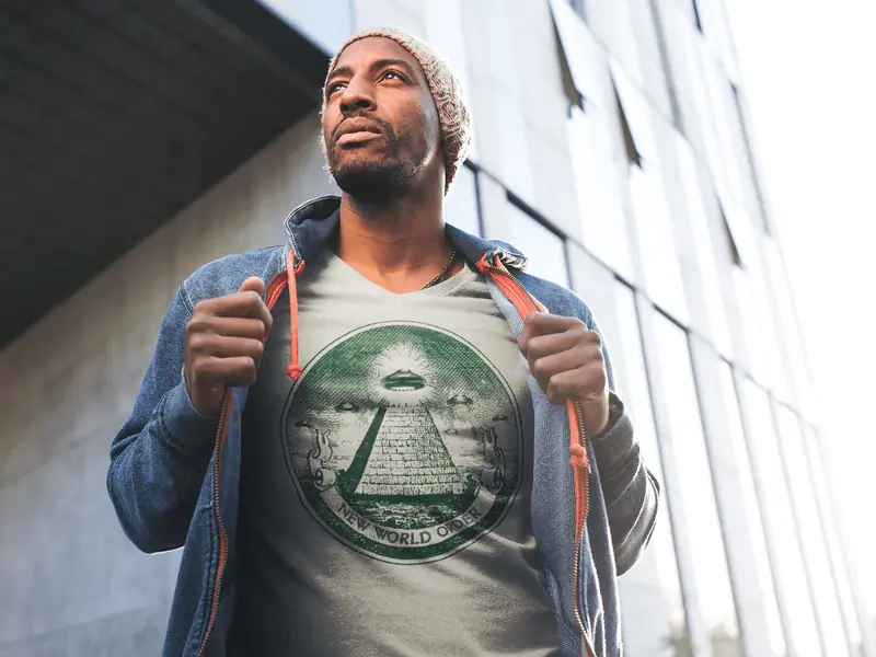 man wearing t-shirt with the ufo hovering over pyramid