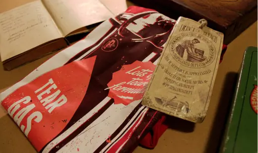 vintage looking photo of a t-shirt folded on the table, surrounded by old books