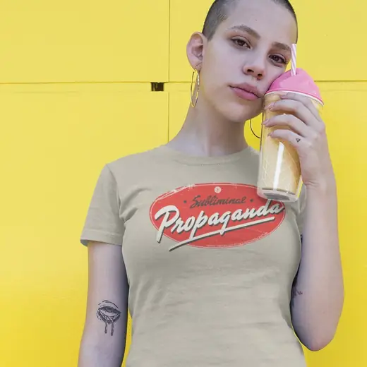 Propaganda Department: The Subliminal Propaganda tee worn against a yellow wall