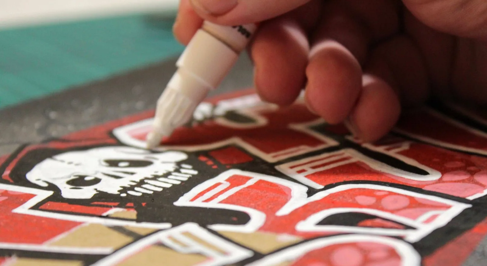 photo of a hand drawing skull graffiti style