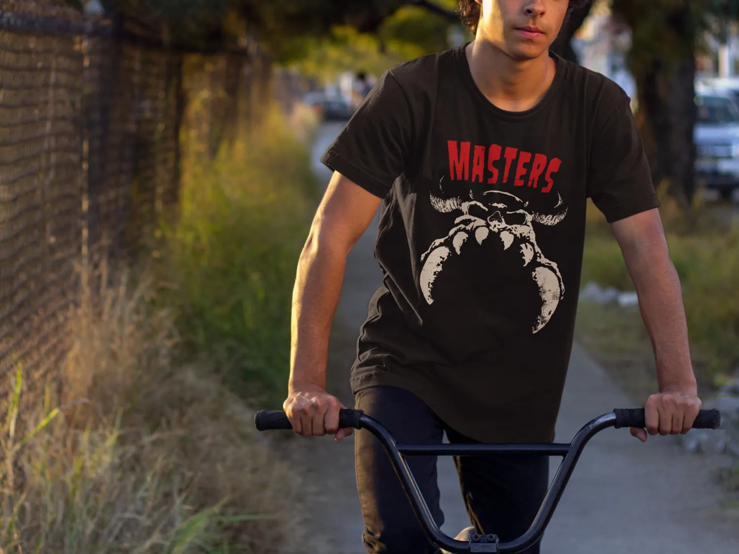 boy on a BMX wearing black tshirt with Masters logo and a danzig skull