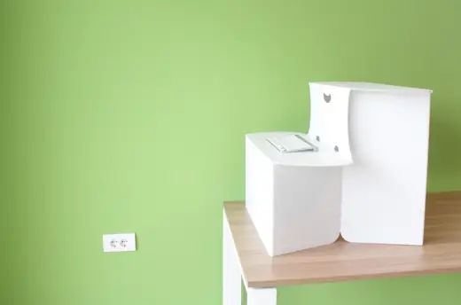 Standify: Standify desk set up on a table against a green wall