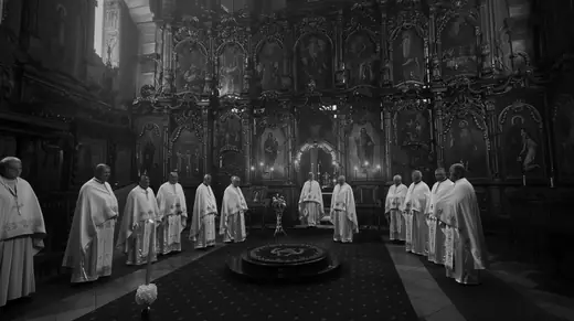 Priests in white vestments before the iconostasis