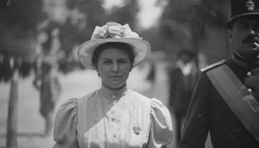 A woman in a white hat beside an officer in uniform