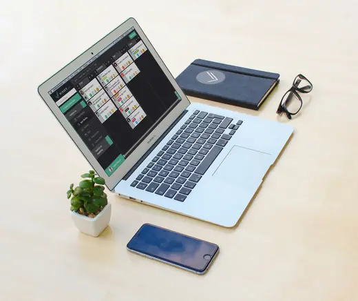 VivifyScrum: VivifyScrum on a laptop and phone, desk photo mockup